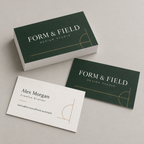 Custom business cards with dark green fronts and white backs, stacked to show both printed sides