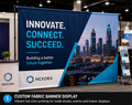 Custom fabric banner with vibrant full color printing displayed at a professional trade show booth for events and indoor advertising.